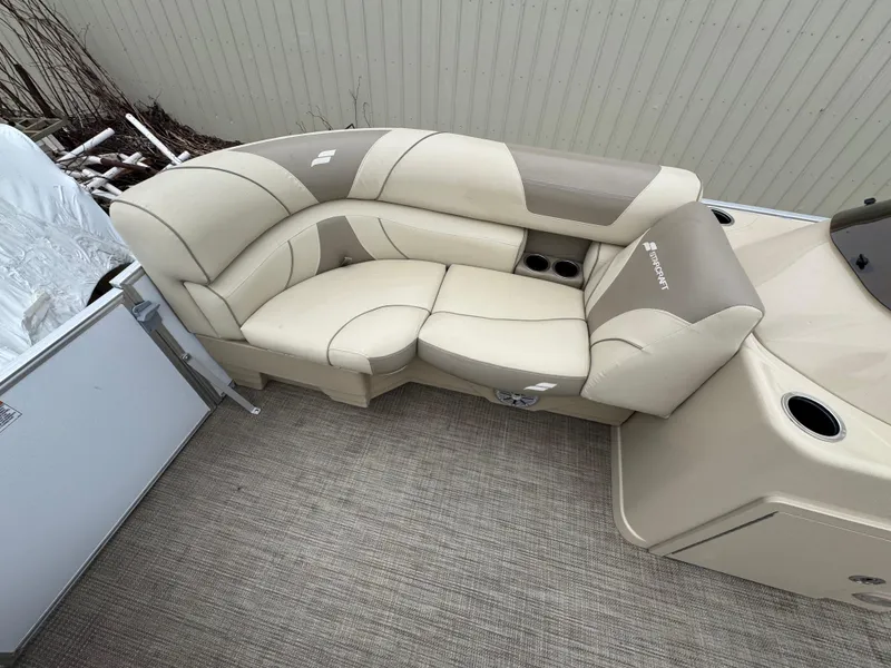 Slide: The Image of 2019 Starcraft EX 20 R boat interior with beige seating and cup holders. - 3