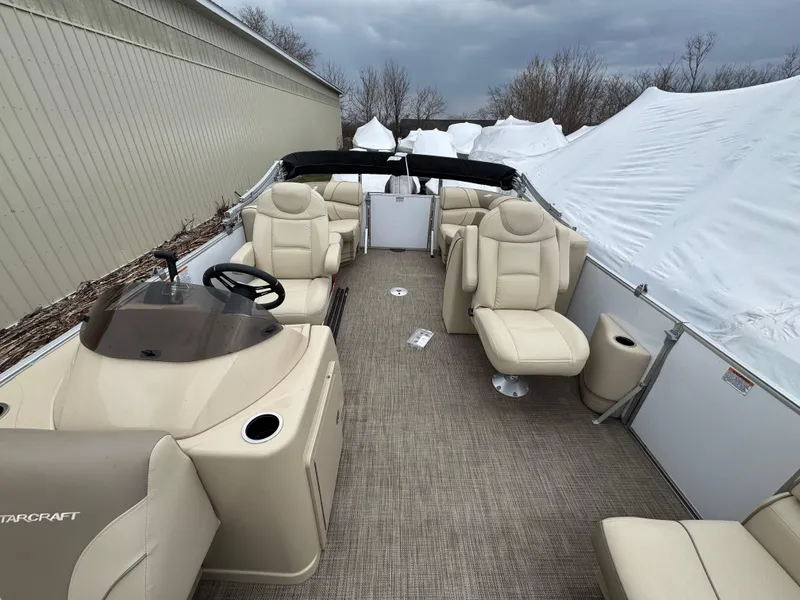 Slide: The Image of 2019 Starcraft EX 20 R pontoon boat with beige seating and steering console. - 4