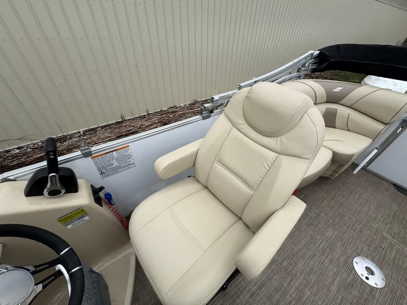 Slide: The Image of 2019 Starcraft EX 20 R boat interior with beige seating and steering wheel. - 5
