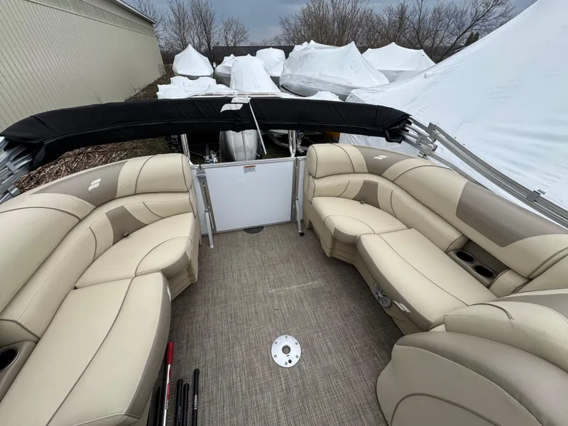 Slide: The Image of 2019 Starcraft EX 20 R pontoon boat with beige seating and covered storage area. - 8