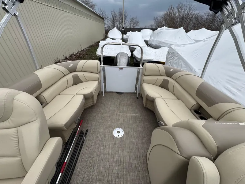 Slide: The Image of 2019 Starcraft EX 20 R pontoon boat with beige seating, stored outdoors. - 9