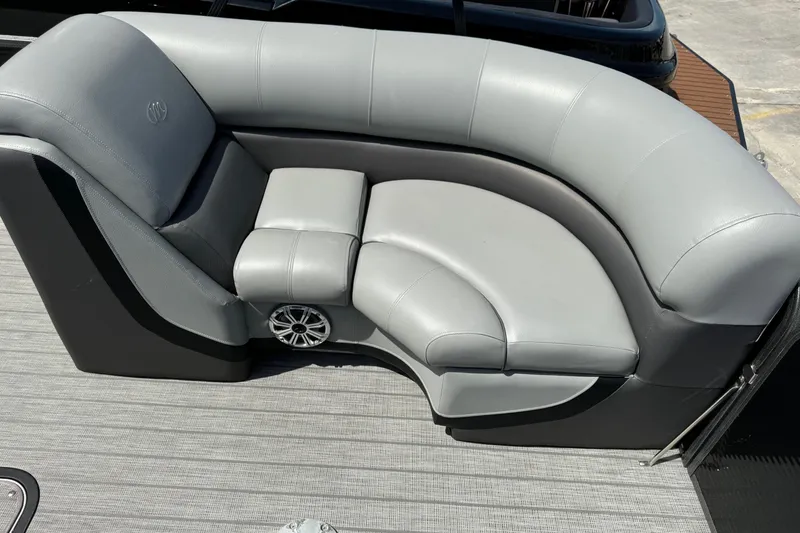 Slide: The Image of Luxurious seating on 2020 Manitou Oasis SR pontoon boat, featuring sleek gray upholstery. - 11