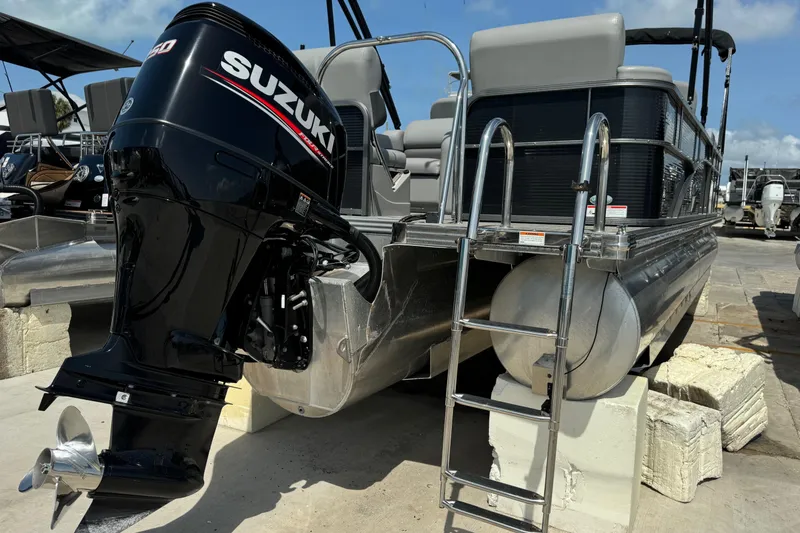 Slide: The Image of 2020 Manitou Oasis SR pontoon boat with Suzuki outboard motor and ladder. - 16