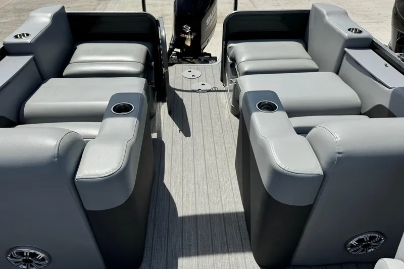 Slide: The Image of 2020 Manitou Oasis SR boat interior with gray seating and cup holders. - 4