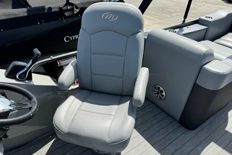 Slide: The Image of 2020 Manitou Oasis SR boat interior with gray captain's chair and steering wheel. - 6