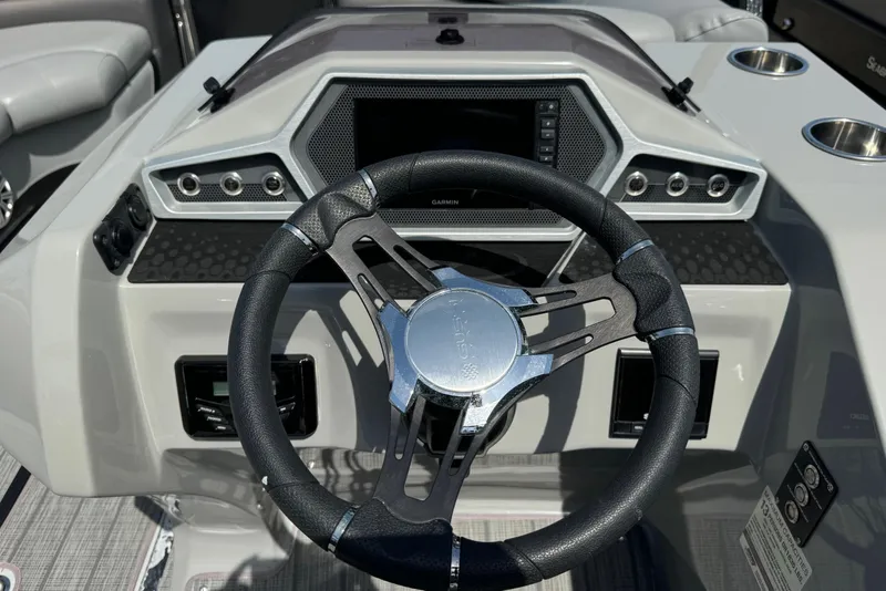 Slide: The Image of Steering wheel and dashboard of 2020 Manitou Oasis SR boat. - 7