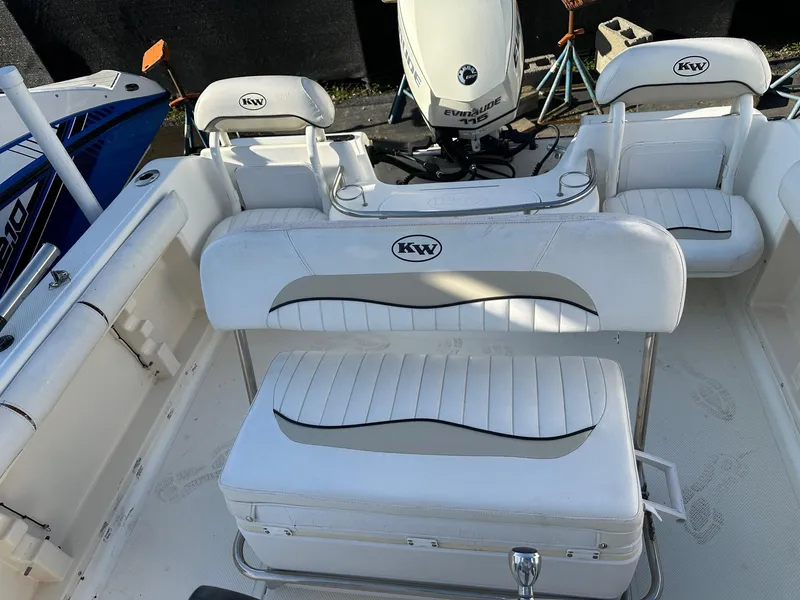 Slide: The Image of 2008 Key West 186 Sportsman boat interior with white seating and Evinrude motor. - 4