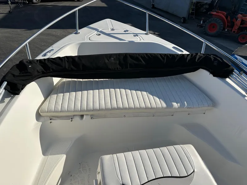 Slide: The Image of 2008 Key West 186 Sportsman boat interior with white seating and black cover. - 5