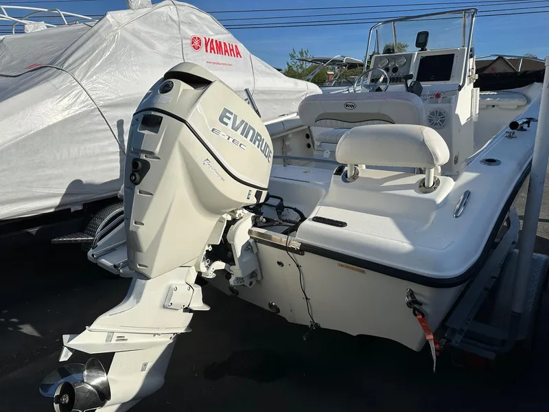 Slide: The Image of 2008 Key West 186 Sportsman boat with Evinrude engine, parked outdoors. - 7