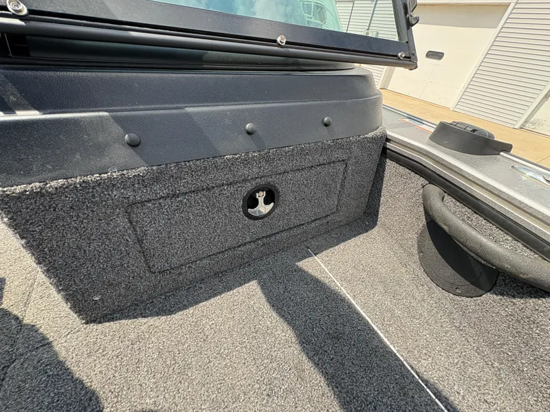 Slide: The Image of Interior view of a 2021 Lund 1975 Pro-V boat, featuring carpeted storage compartment. - 12