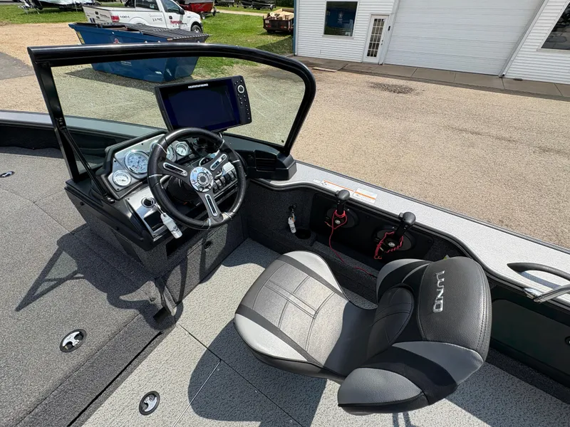 Slide: The Image of Interior of 2021 Lund 1975 Pro-V boat with steering wheel and seating. - 17