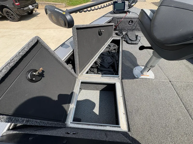 Slide: The Image of 2021 Lund 1975 Pro-V boat with open storage compartments and fishing equipment. - 23