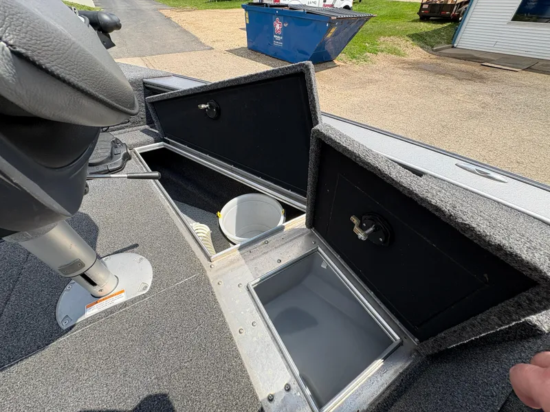 Slide: The Image of 2021 Lund 1975 Pro-V boat storage compartments open, showcasing interior space and design. - 24