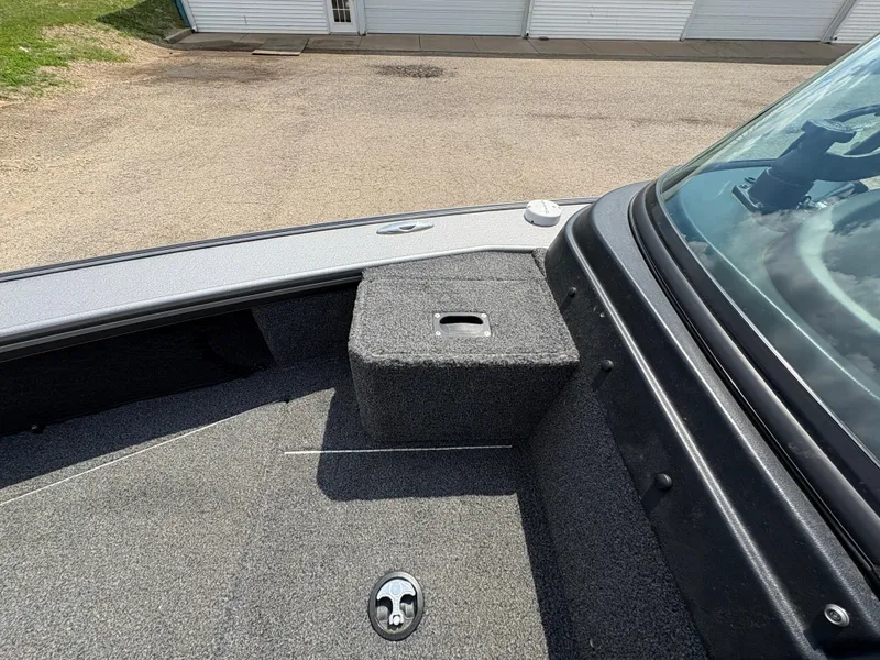 Slide: The Image of Lund 1975 Pro-V 2021 boat interior with carpeted deck and windshield. - 26