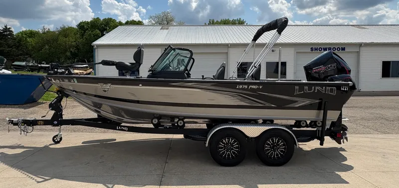 Slide: The Image of 2021 Lund 1975 Pro-V boat on trailer outside a showroom. - 3