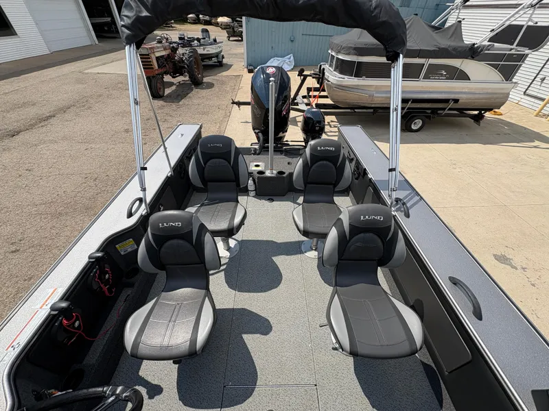 Slide: The Image of Interior of a 2021 Lund 1975 Pro-V boat with four seats and a motor. - 36