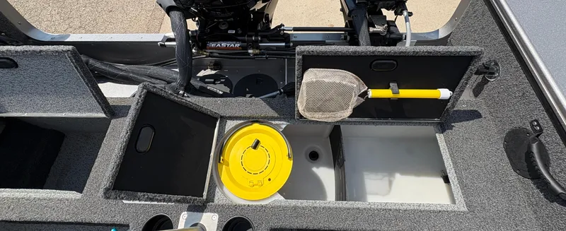 Slide: The Image of Interior of a 2021 Lund 1975 Pro-V boat with storage compartments and fishing gear. - 42