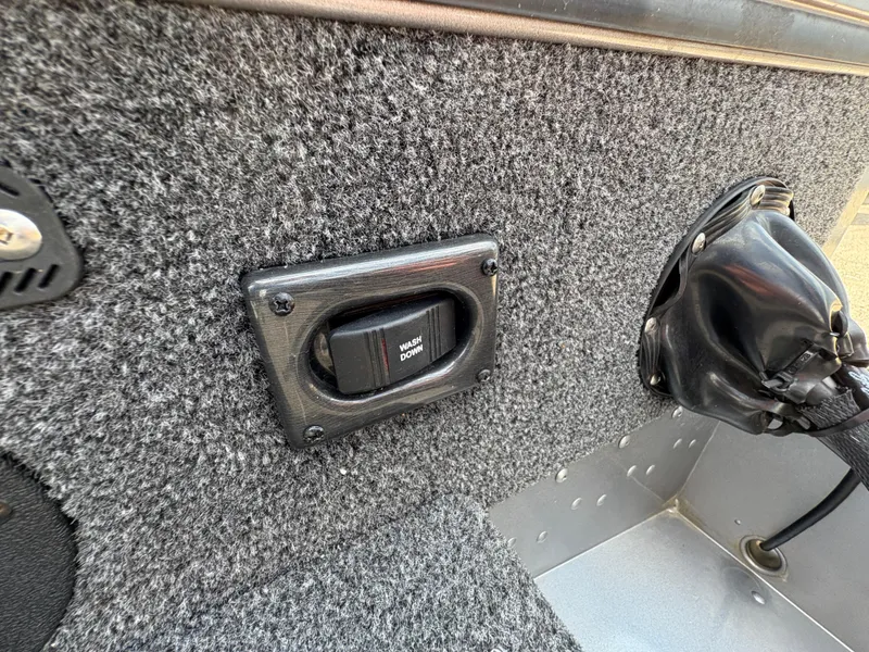 Slide: The Image of Interior of 2021 Lund 1975 Pro-V boat with carpeted panel and switch. - 44