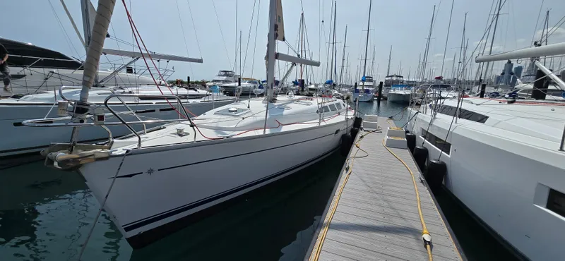 The Image of 2006 Jeanneau Sun Odyssey 40.3 sailboat docked at marina, surrounded by other vessels. - 0