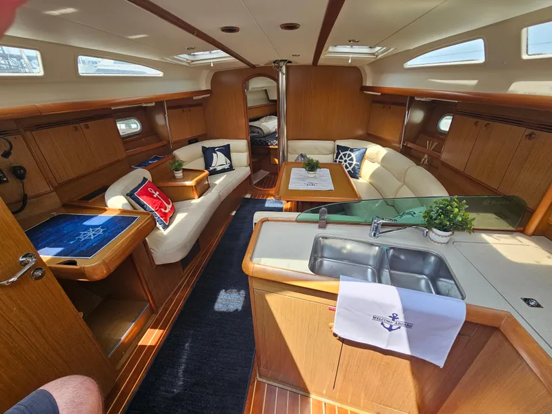 Slide: The Image of Interior of 2006 Jeanneau Sun Odyssey 40.3 yacht with elegant wood finish and cozy seating. - 10