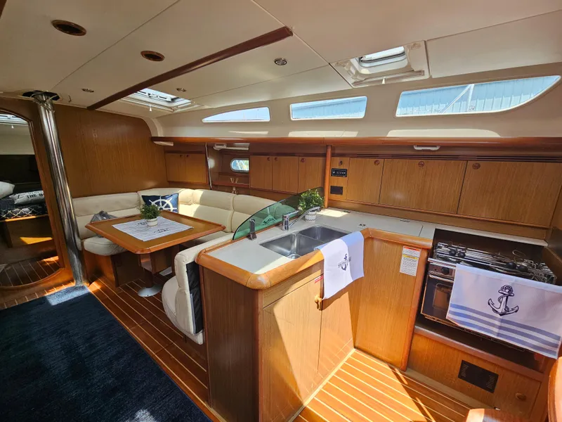 Slide: The Image of Luxurious interior of 2006 Jeanneau Sun Odyssey 40.3 yacht with wood finish and modern amenities. - 14
