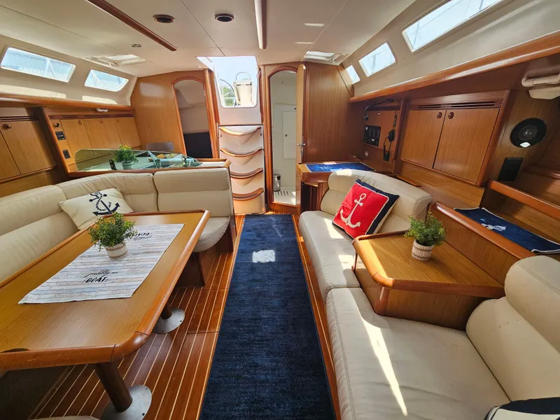 Slide: The Image of Luxurious interior of 2006 Jeanneau Sun Odyssey 40.3 yacht with elegant wood finish and plush seating. - 16