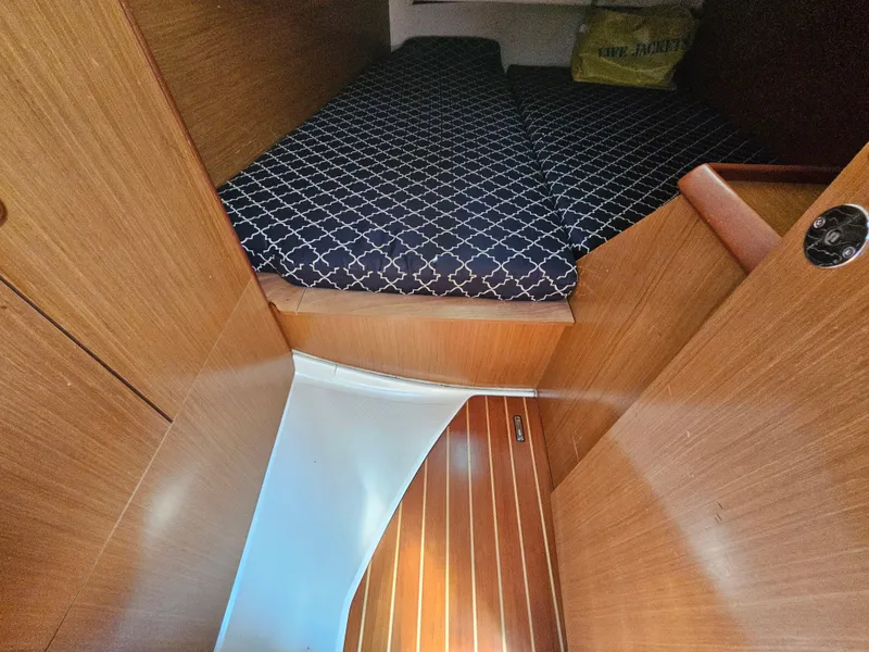 Slide: The Image of Interior cabin of 2006 Jeanneau Sun Odyssey 40.3 with wooden finish and patterned bedding. - 17