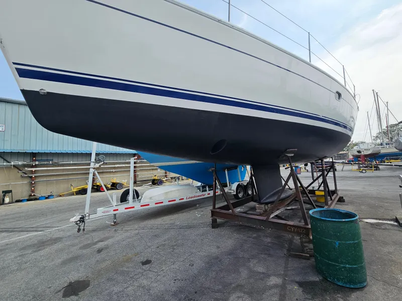 Slide: The Image of Jeanneau Sun Odyssey 40.3 sailboat on dry dock, 2006 model, with visible keel and hull. - 3