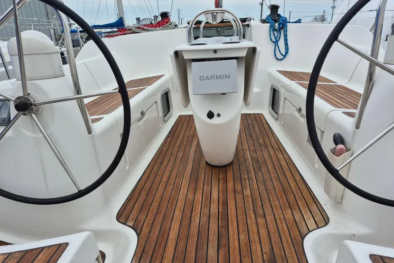 Slide: The Image of Cockpit of 2006 Jeanneau Sun Odyssey 40.3 sailboat with dual steering wheels and Garmin navigation. - 4