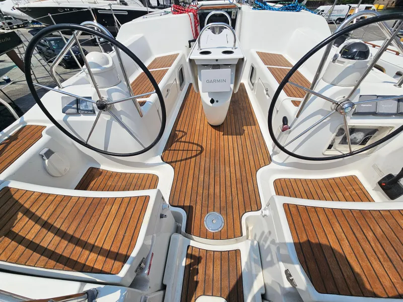 Slide: The Image of 2006 Jeanneau Sun Odyssey 40.3 yacht cockpit with dual steering wheels and teak flooring. - 7
