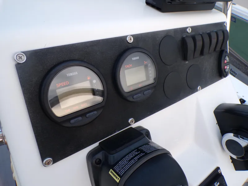 Slide: The Image of 2006 Mako 1801 Inshore boat dashboard with Yamaha speed and tachometer gauges. - 10