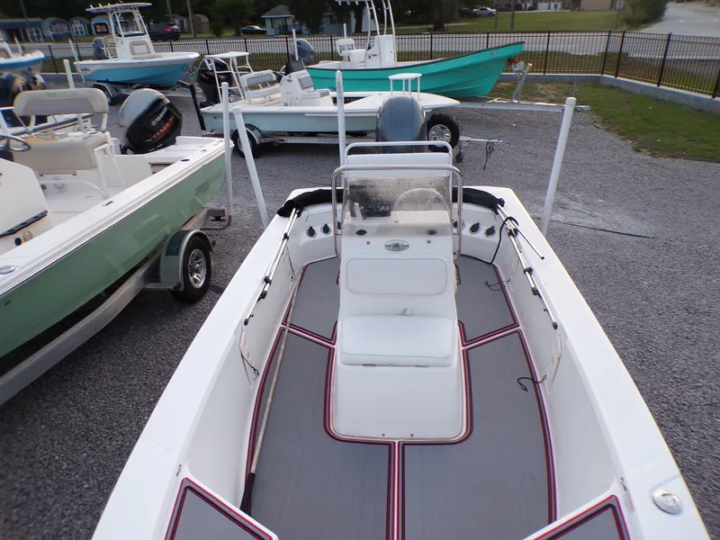 Slide: The Image of 2006 Mako 1801 Inshore boat displayed in a marina setting. - 13