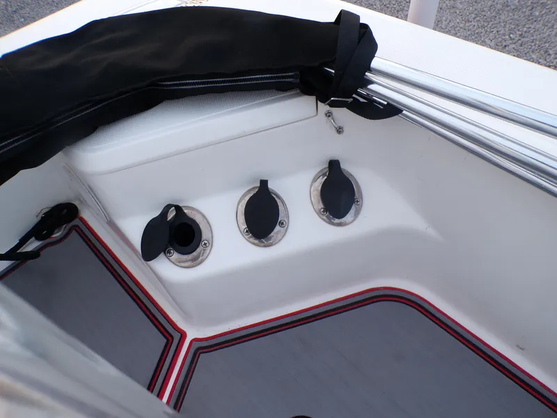 Slide: The Image of 2006 Mako 1801 Inshore boat interior with rod holders and protective cover. - 17