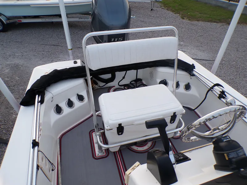 Slide: The Image of 2006 Mako 1801 Inshore boat interior with seating and steering wheel. - 6