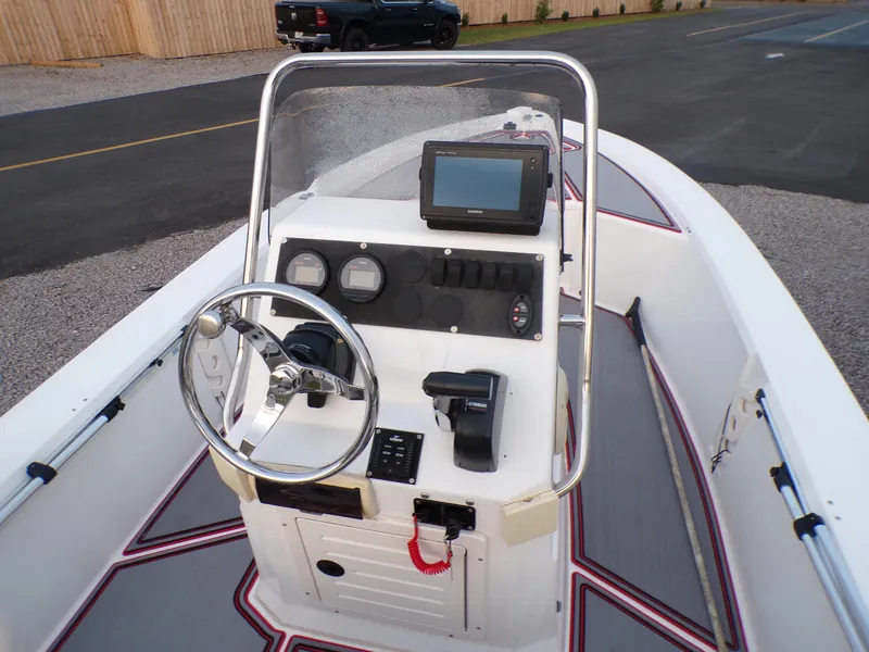 Slide: The Image of 2006 Mako 1801 Inshore boat console with steering wheel and navigation equipment. - 7