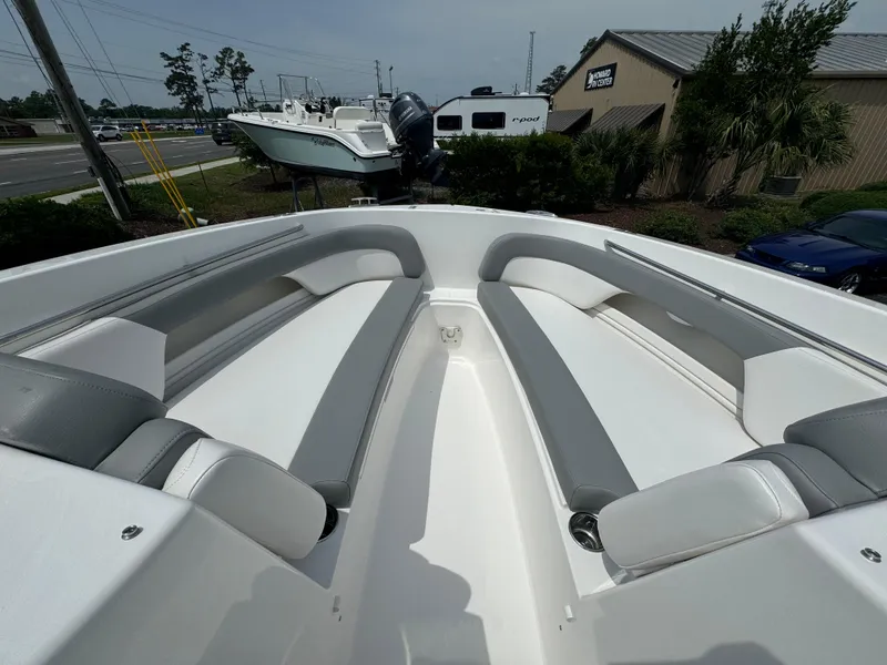 Slide: The Image of 2025 Albemarle 31 Dual Console boat on trailer, front view, parked near palm trees. - 12