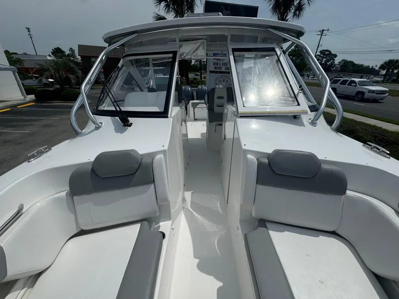 Slide: The Image of 2025 Albemarle 31 Dual Console with triple outboard engines, parked outdoors. - 13