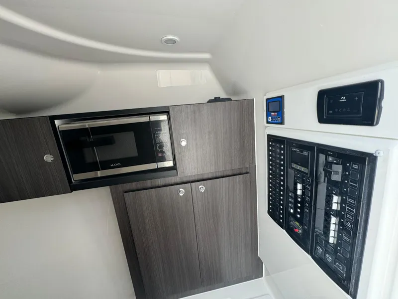 Slide: The Image of 2025 Albemarle 31 Dual Console boat interior with seating and storage compartments. - 14