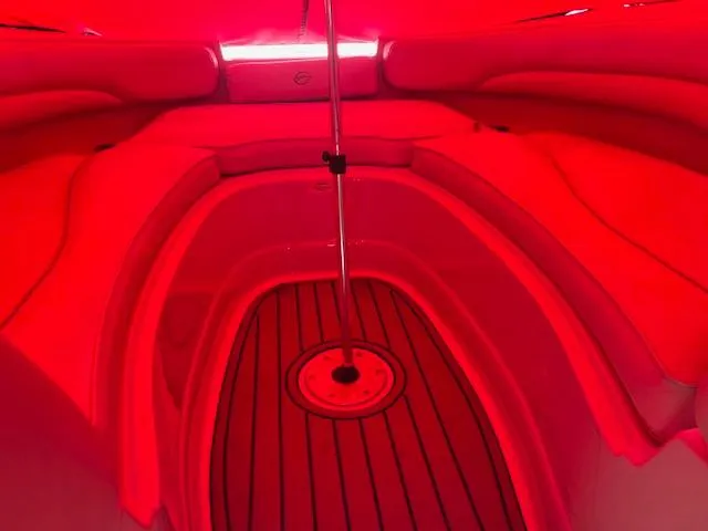 Slide: The Image of 2007 Crownline 240 EX boat interior with red lighting and wooden flooring. - 10