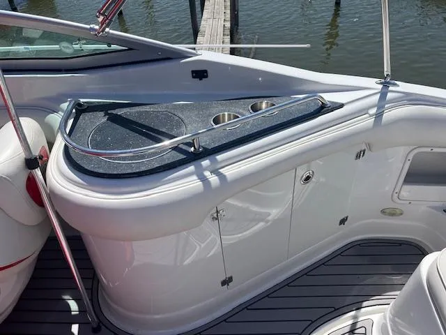 Slide: The Image of 2007 Crownline 240 EX boat interior with sleek countertop and cup holders. - 12