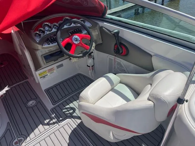 Slide: The Image of 2007 Crownline 240 EX boat interior with red accents and steering wheel. - 5