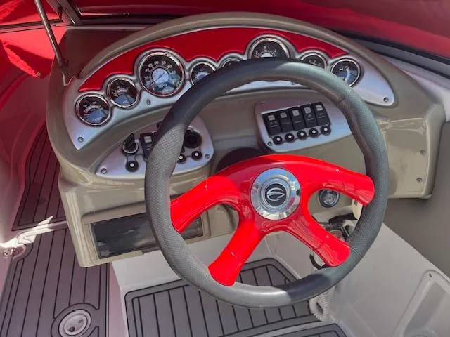 Slide: The Image of 2007 Crownline 240 EX boat dashboard with red steering wheel and instrument panel. - 7