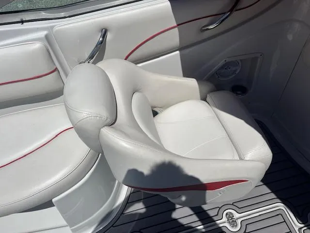 Slide: The Image of 2007 Crownline 240 EX boat interior with white seating and red accents. - 8