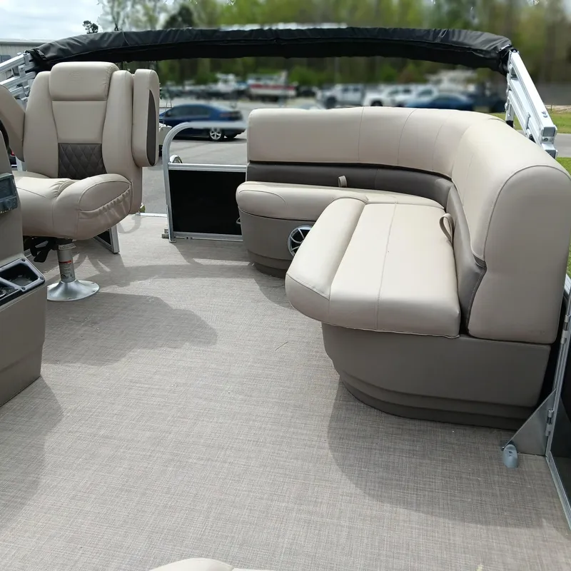 Slide: The Image of 2025 Sun Tracker Party Barge 16 DLX interior with beige seating and spacious layout. - 8