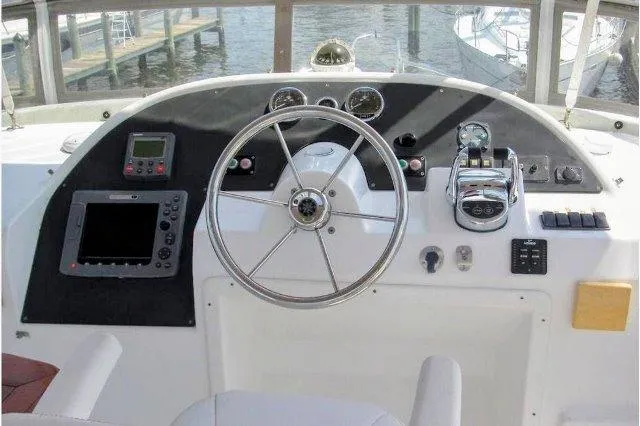 Slide: The Image of Helm of 2006 Beneteau Swift Trawler 42 with navigation instruments and steering wheel. - 16