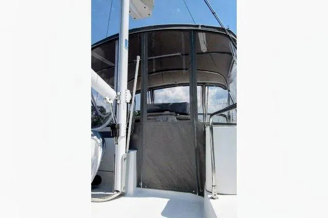 Slide: The Image of 2006 Beneteau Swift Trawler 42, rear view, showcasing covered deck and canopy. - 19