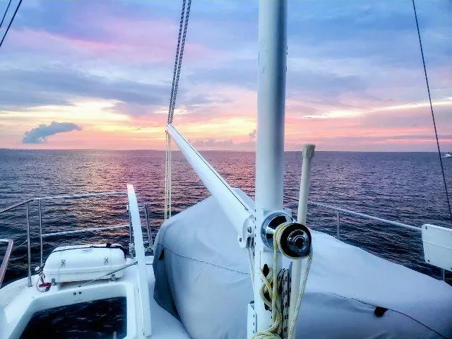 Slide: The Image of Beneteau Swift Trawler 42, 2006, at sea during a vibrant sunset. - 20