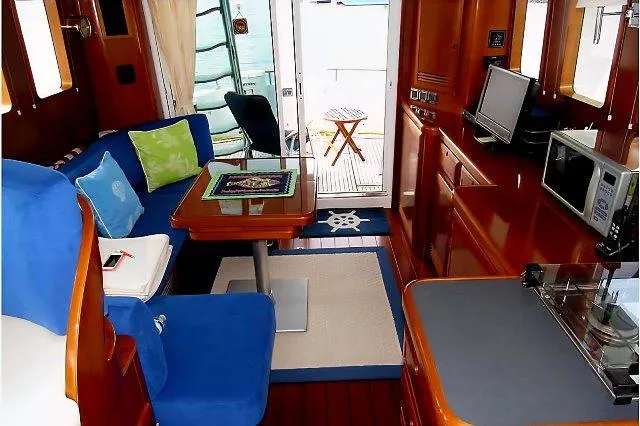 Slide: The Image of Interior of 2006 Beneteau Swift Trawler 42 with cozy seating and modern amenities. - 24
