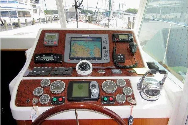 Slide: The Image of Helm of 2006 Beneteau Swift Trawler 42 with navigation instruments and controls. - 29