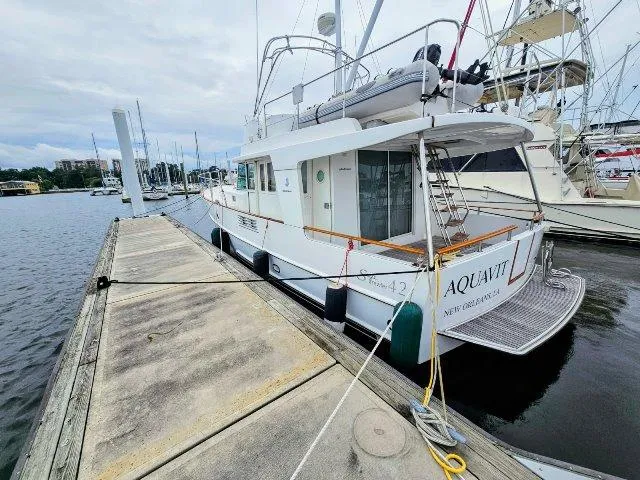 Slide: The Image of 2006 Beneteau Swift Trawler 42 docked at marina, side view. - 3